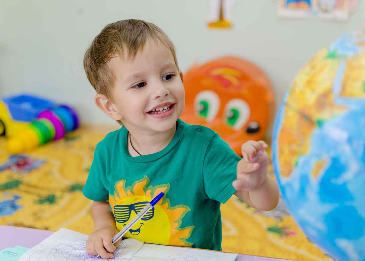 A Lumora kindergarten child working carefully on a project at a table